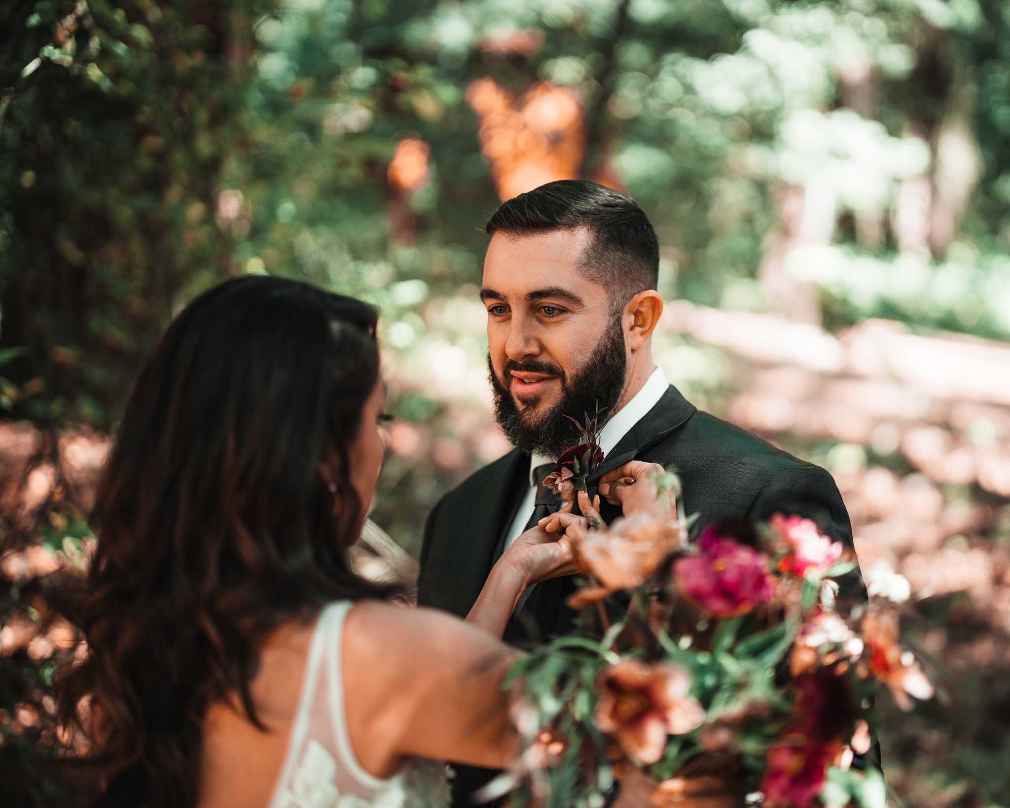 Erika pinning a boutonnière on Kenneth